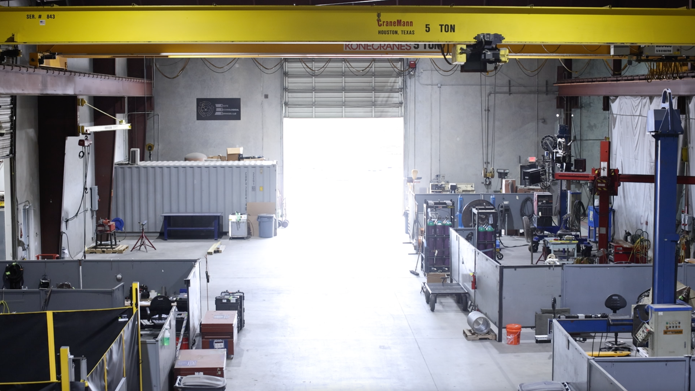 View of facility floor from a high vantage point as the large doors are opening.
